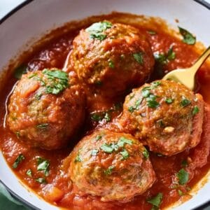 meatballs with bowl and spoon and garnish