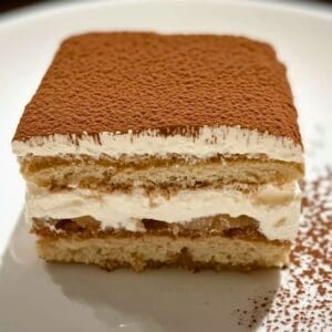 easy homemade tiramisu dusted with cocoa powder in a white baking dish