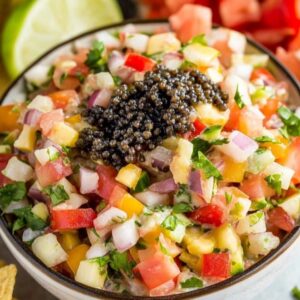 easy cowboy caviar dip with black beans avocado corn and cilantro in white bowl