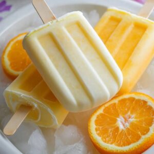 easy 2 ingredient orange creamsicle popsicles on white background
