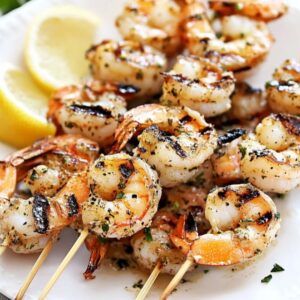 easy garlic grilled shrimp skewers with fresh herb marinade on white plate