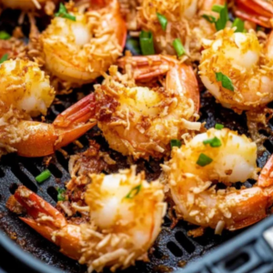 Crispy air fryer coconut shrimp golden brown on a plate served with sweet chili dipping sauce