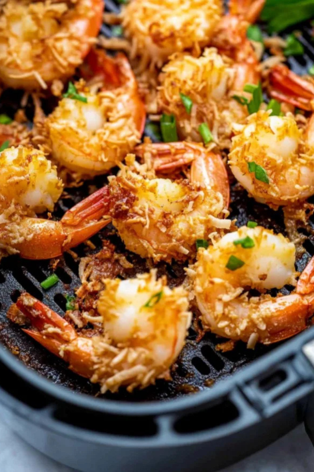 Crispy air fryer coconut shrimp golden brown on a plate served with sweet chili dipping sauce