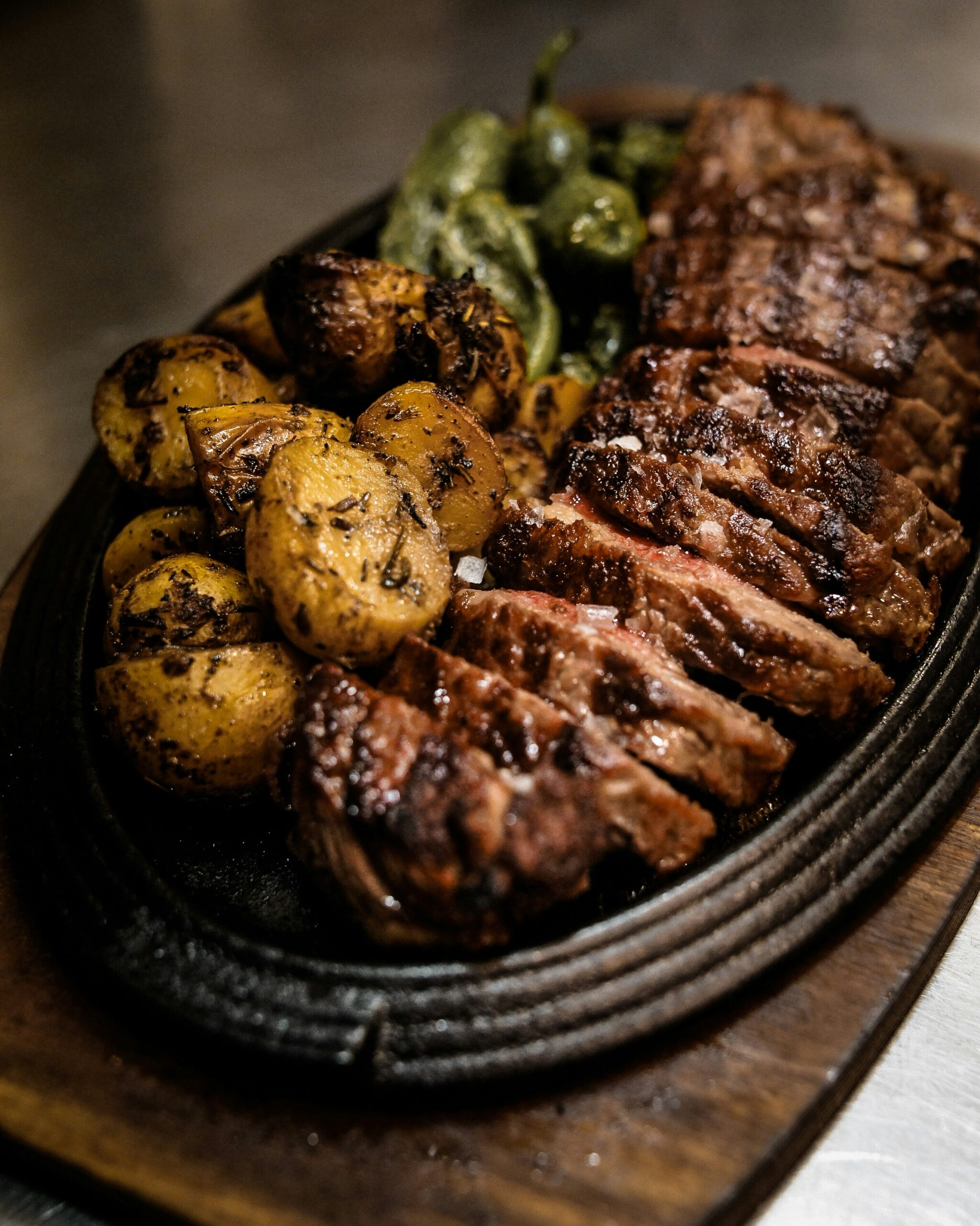 Garlic butter steak bites and potatoes in a cast iron skillet
