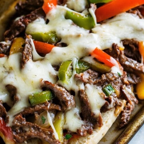 crockpot philly cheesesteak sandwich with melted provolone