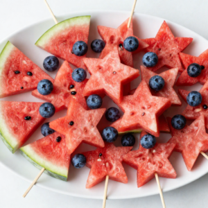watermelon stars on skewers with blueberries served on a platter