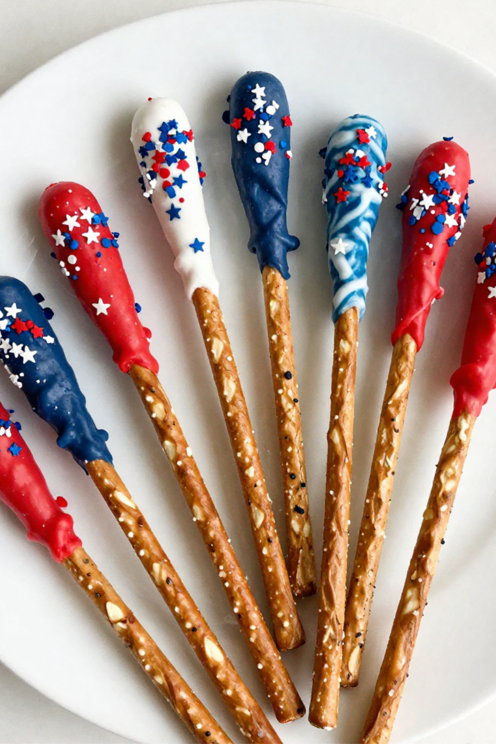 4th of July pretzel rods dipped in red white and blue candy melts with star sprinkles